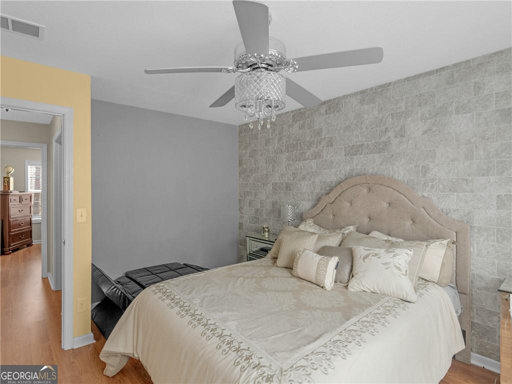 355 Parker Road Covington, GA 30014 - Photo 36 of 60 a bedroom with a bed and a chandelier