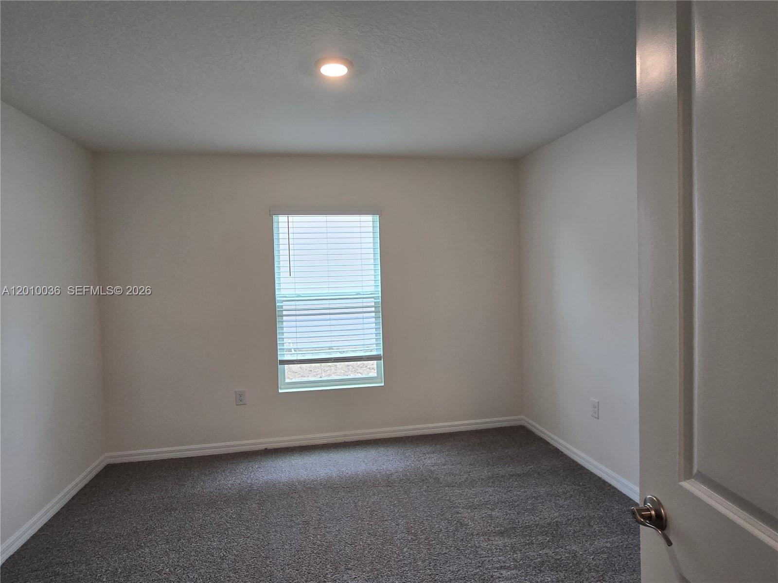 9871 Southeast 161st Lane Road Summerfield, FL 34491 - Photo 13 of 31 an empty room with a window