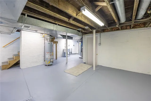 a view of water heater room with staircase