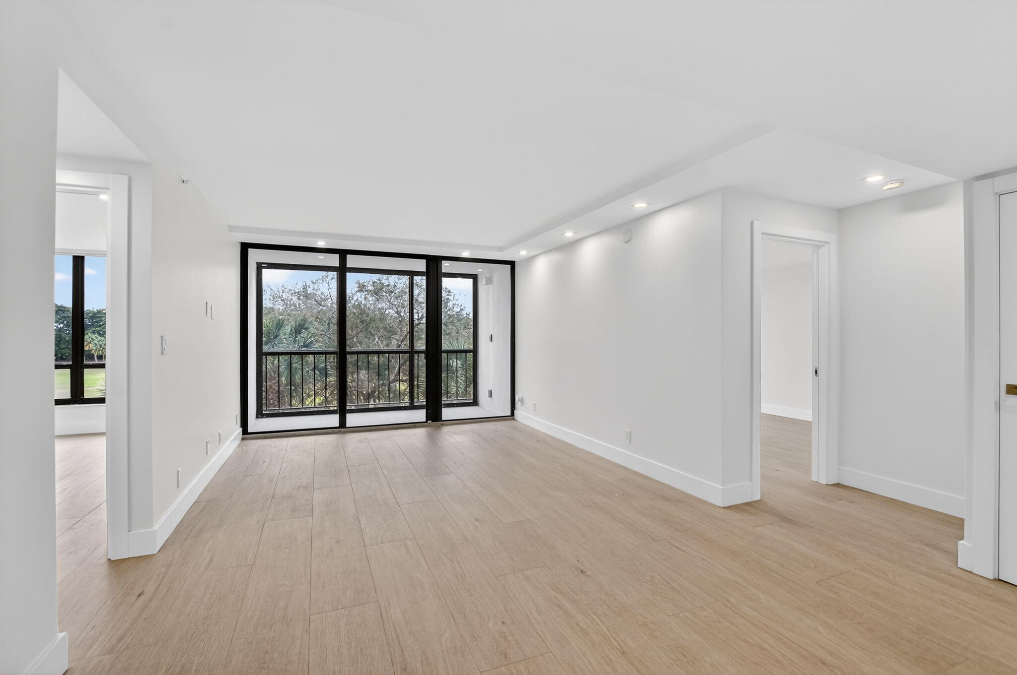 7835 Lakeside Boulevard, Unit 946 Boca Raton, FL 33434 - Photo 6 of 20 wooden floor in an empty room with a window