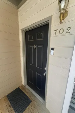 a view of a door and wooden floor