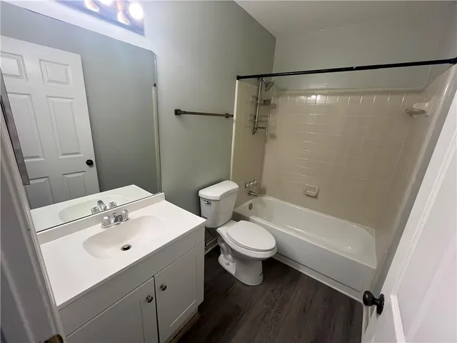 a bathroom with a sink toilet a mirror and shower