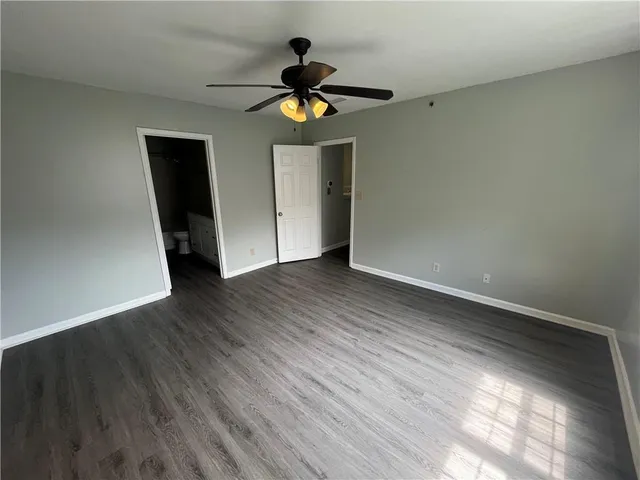 a view of a livingroom with wooden floor and a ceiling fan