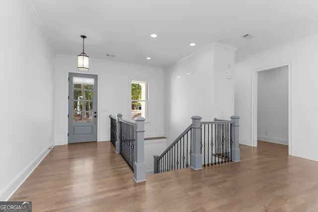 a living room with furniture a large window and a fireplace
