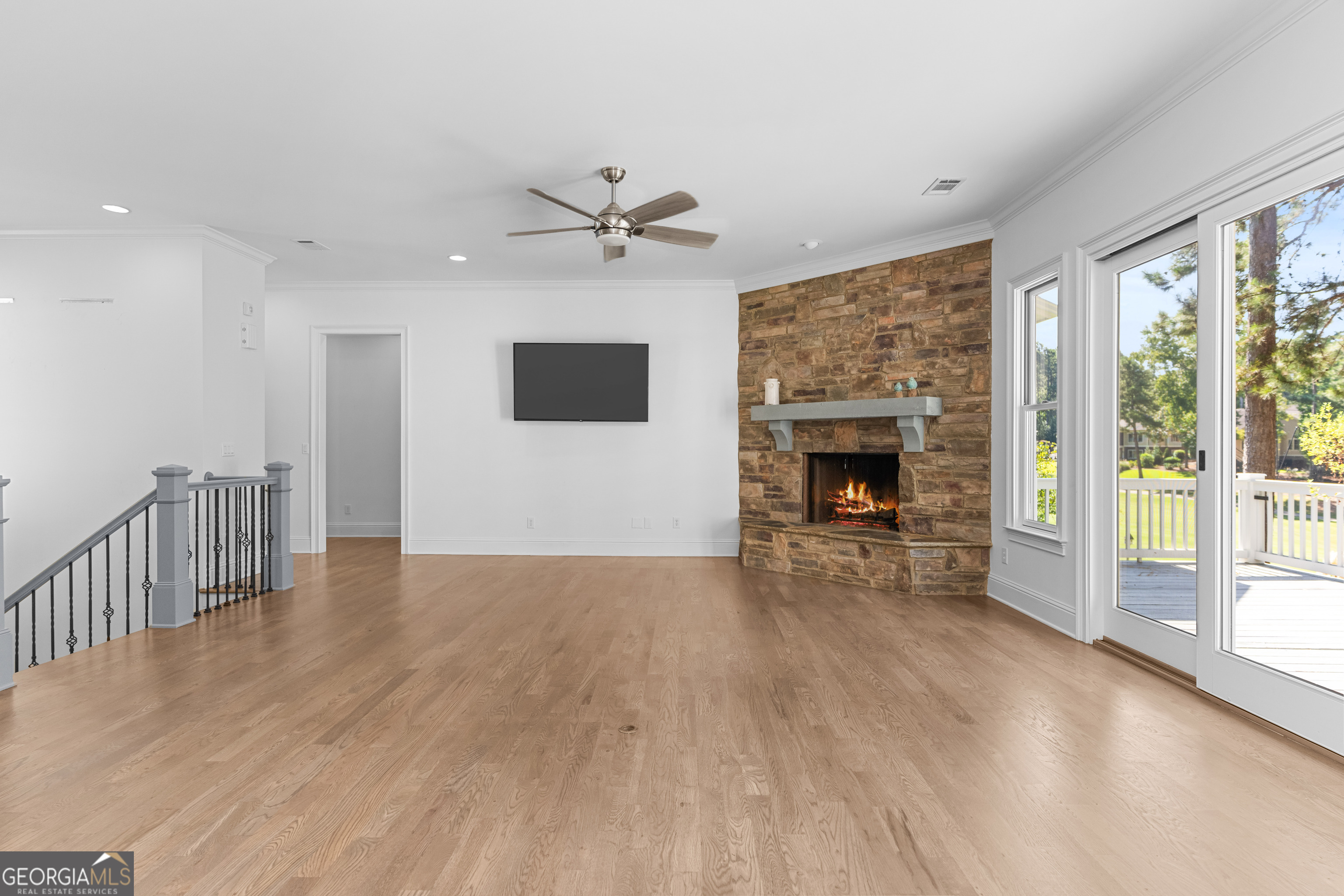 1011 Ridge Terrace Greensboro, GA 30642 - Photo 17 of 72 a view of empty room with wooden floor and fireplace