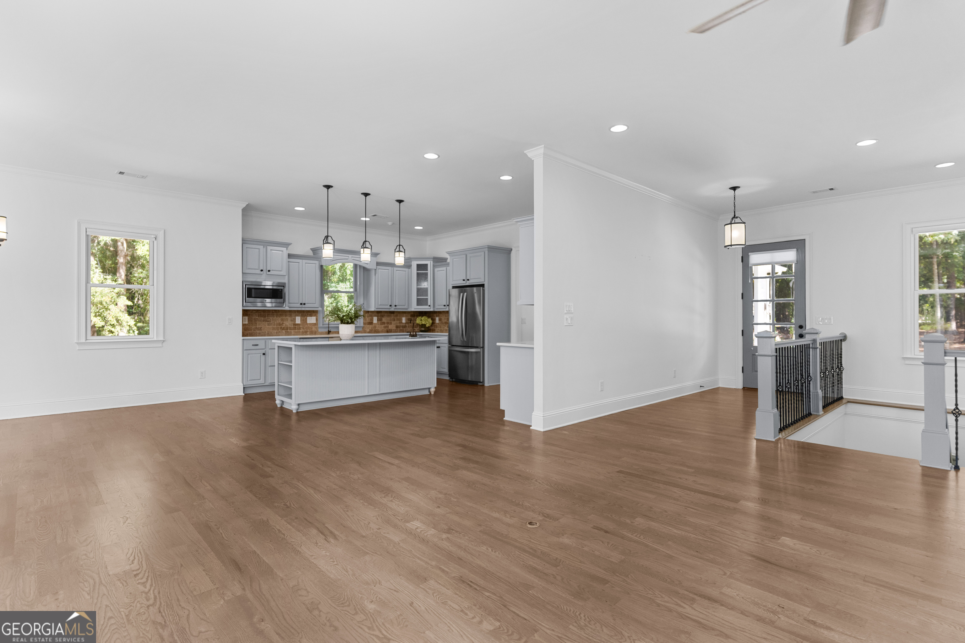 1011 Ridge Terrace Greensboro, GA 30642 - Photo 20 of 72 a view of a big room with wooden floor and a kitchen