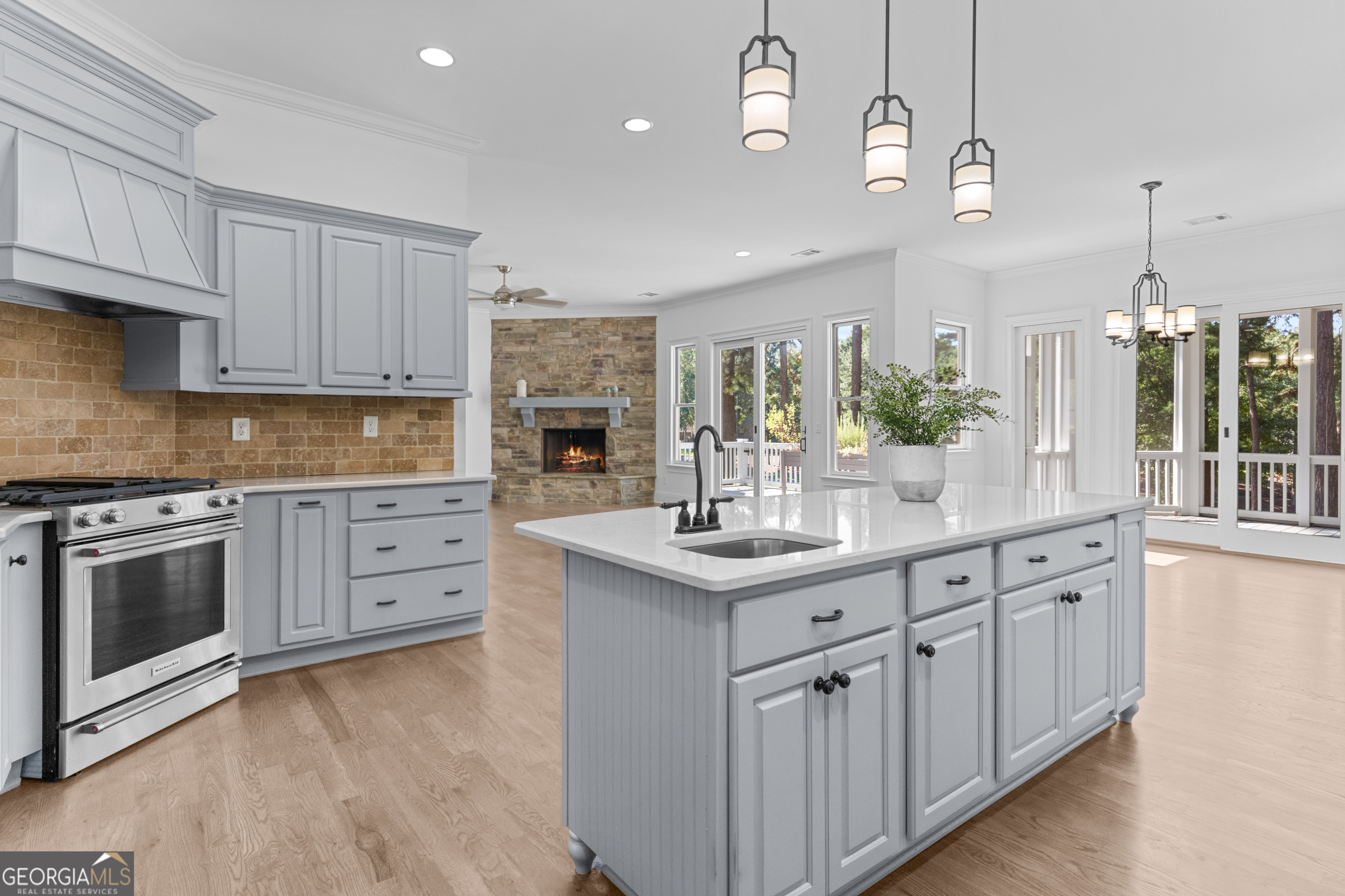 1011 Ridge Terrace Greensboro, GA 30642 - Photo 24 of 72 a kitchen with kitchen island granite countertop a sink stainless steel appliances and cabinets