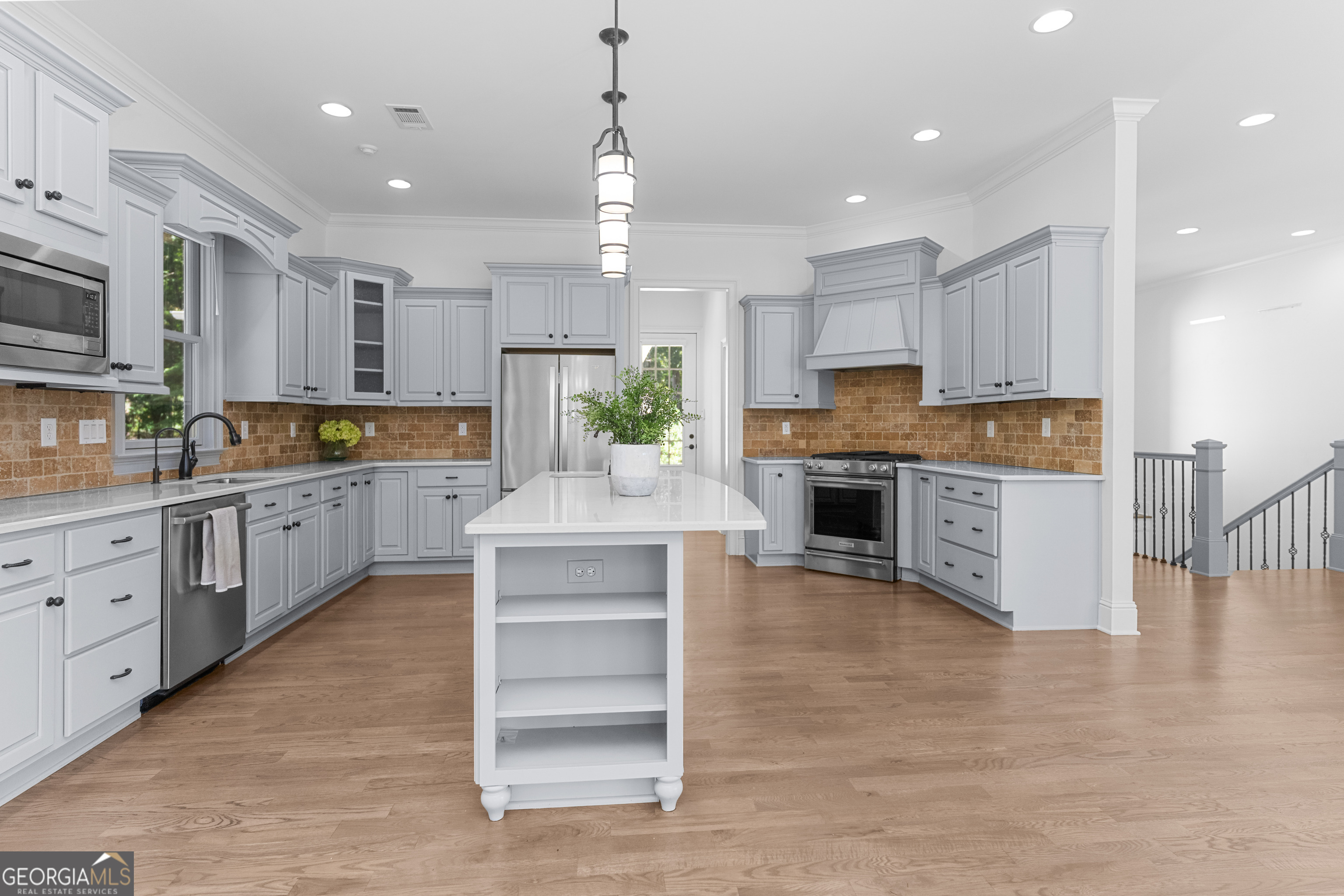 1011 Ridge Terrace Greensboro, GA 30642 - Photo 26 of 72 a large kitchen with cabinets chairs and wooden floor