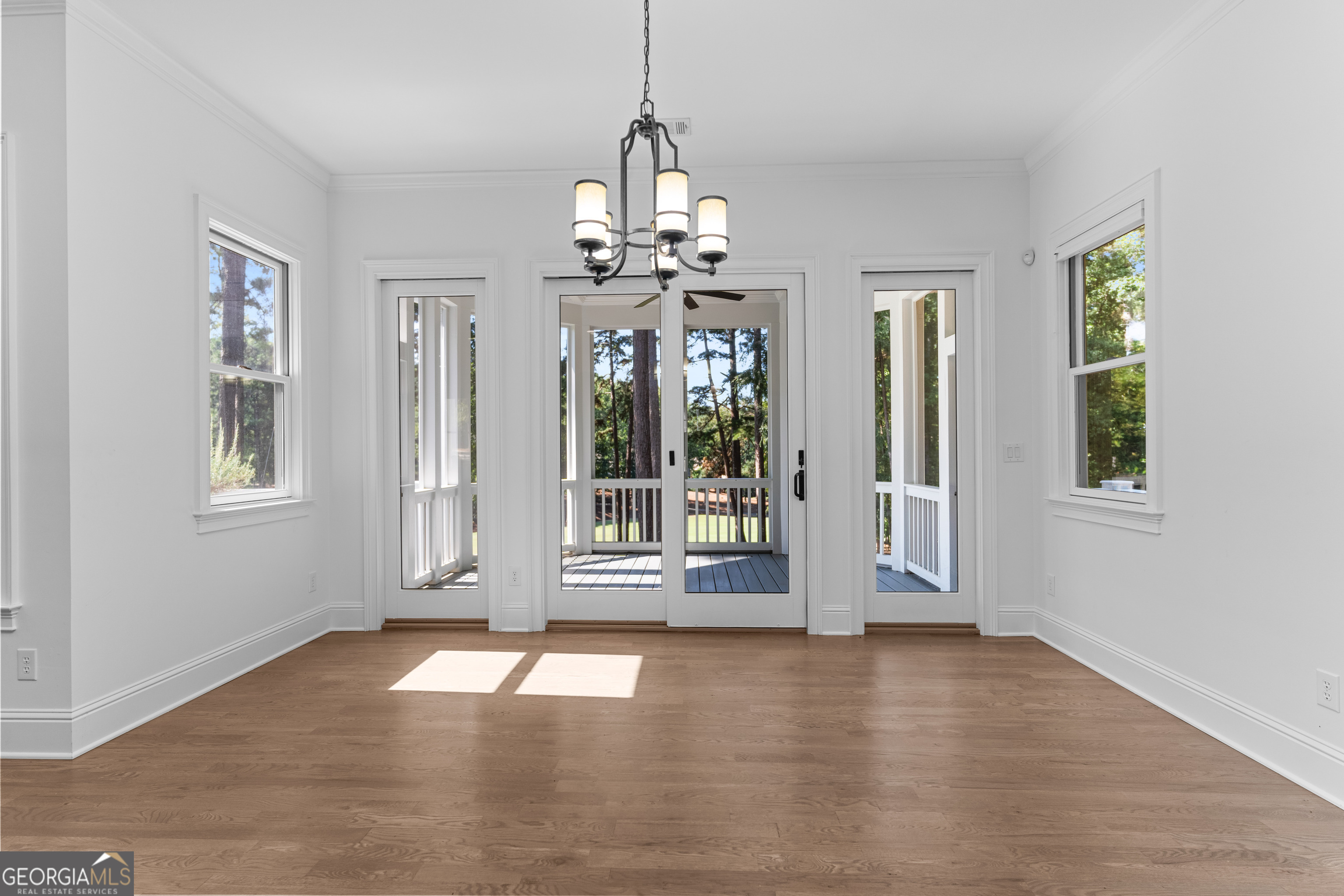 1011 Ridge Terrace Greensboro, GA 30642 - Photo 27 of 72 a view of an empty room with a window and wooden floor