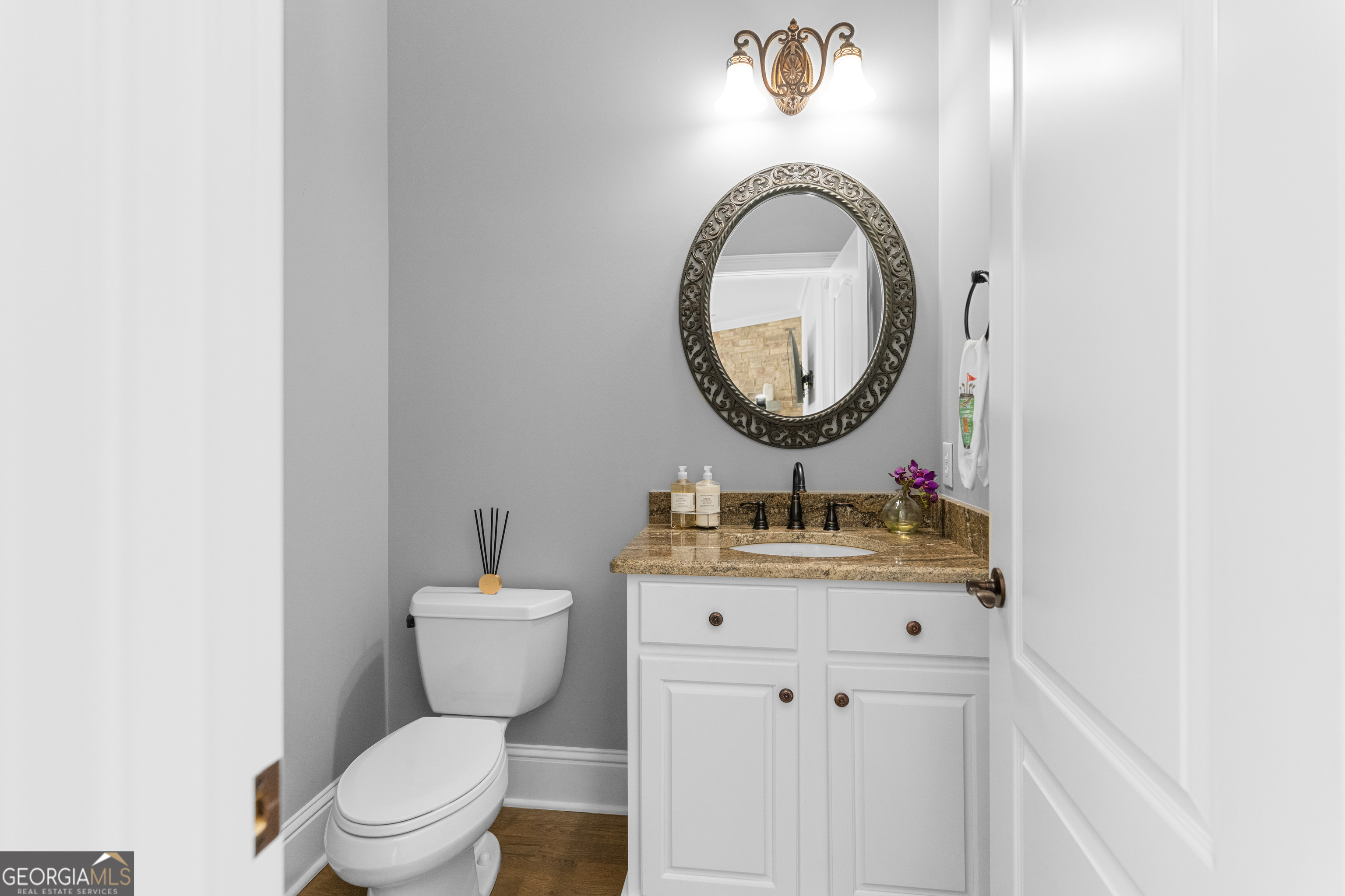 1011 Ridge Terrace Greensboro, GA 30642 - Photo 31 of 72 a bathroom with a granite countertop toilet a sink and a mirror