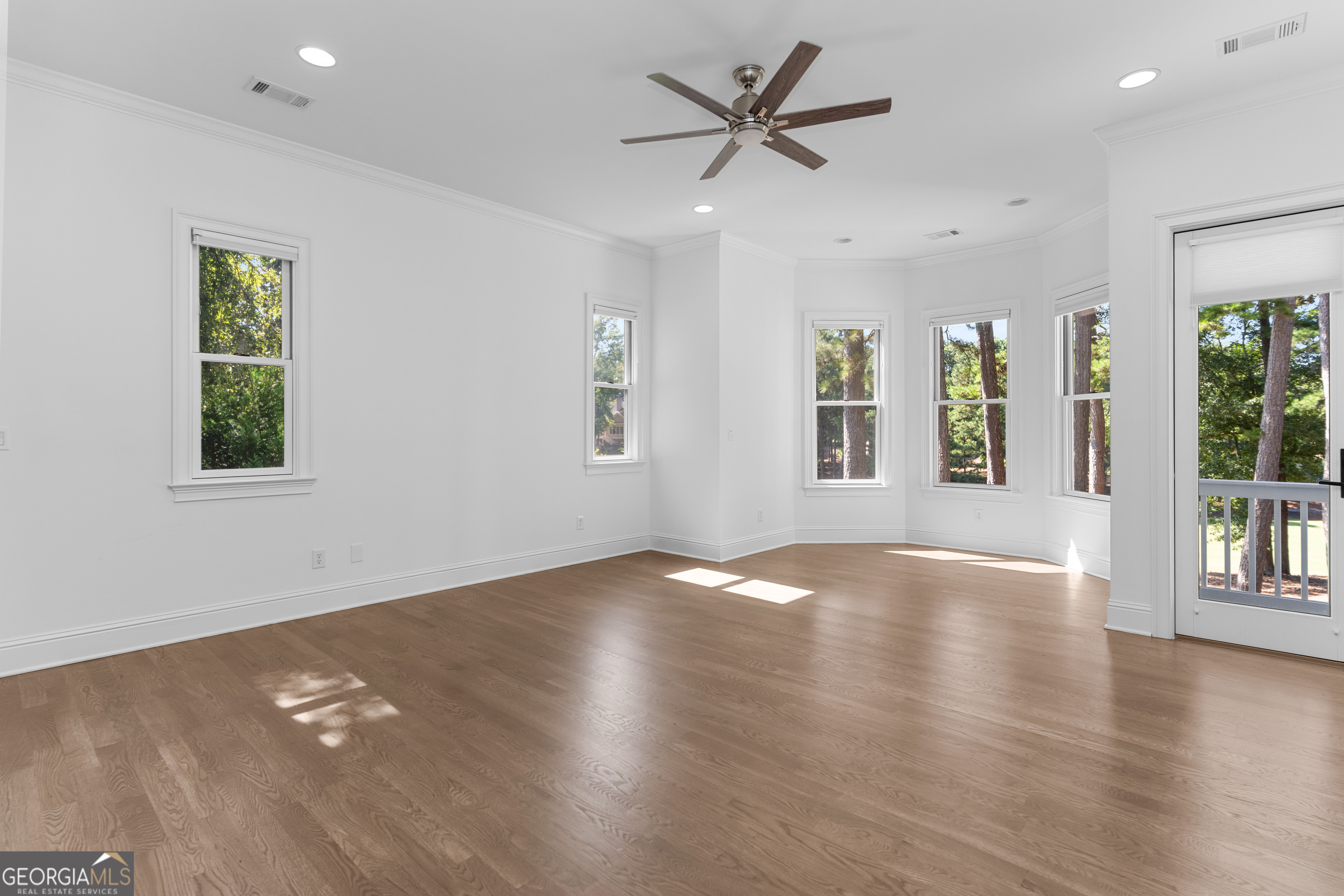 1011 Ridge Terrace Greensboro, GA 30642 - Photo 32 of 72 a view of an empty room with a window and wooden floor