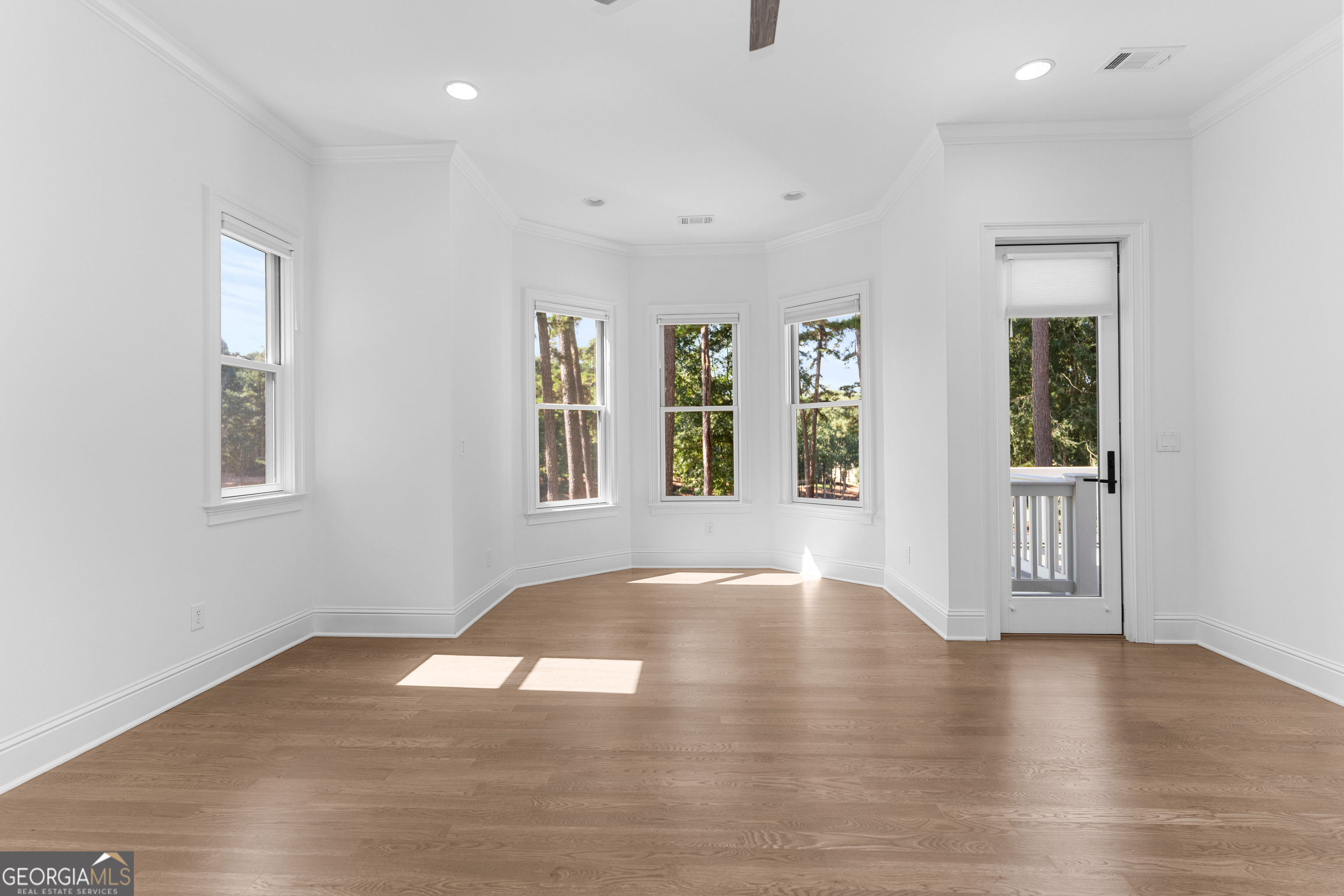 1011 Ridge Terrace Greensboro, GA 30642 - Photo 33 of 72 an empty room with wooden floor and windows