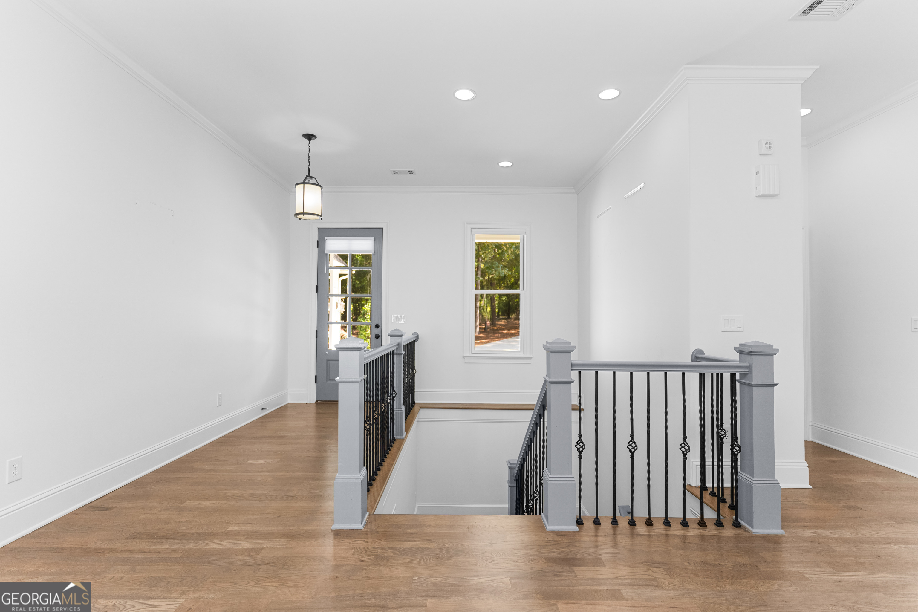 1011 Ridge Terrace Greensboro, GA 30642 - Photo 50 of 72 an empty room with wooden floor and windows