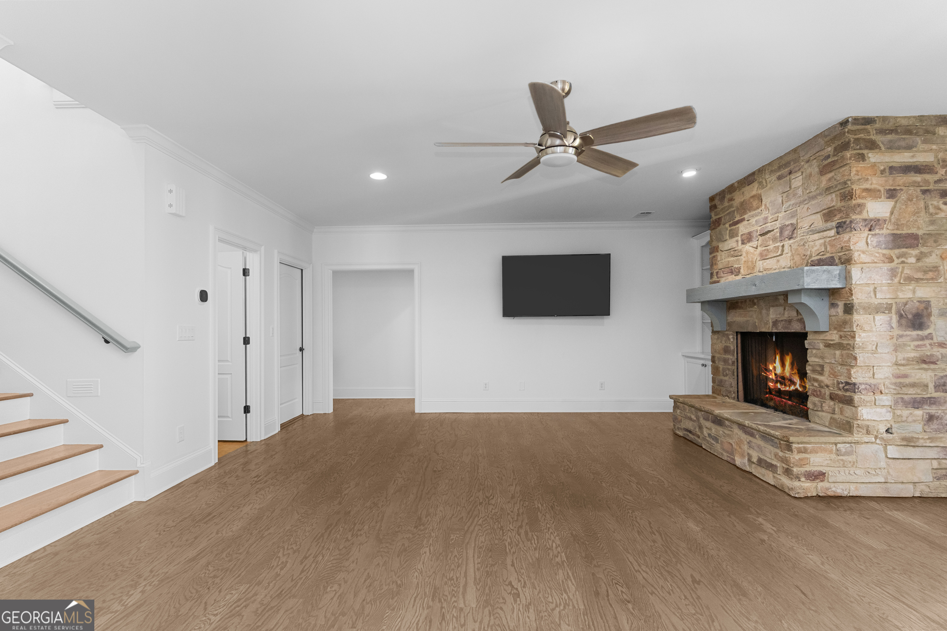 1011 Ridge Terrace Greensboro, GA 30642 - Photo 51 of 72 a living room with a fireplace and a ceiling fan