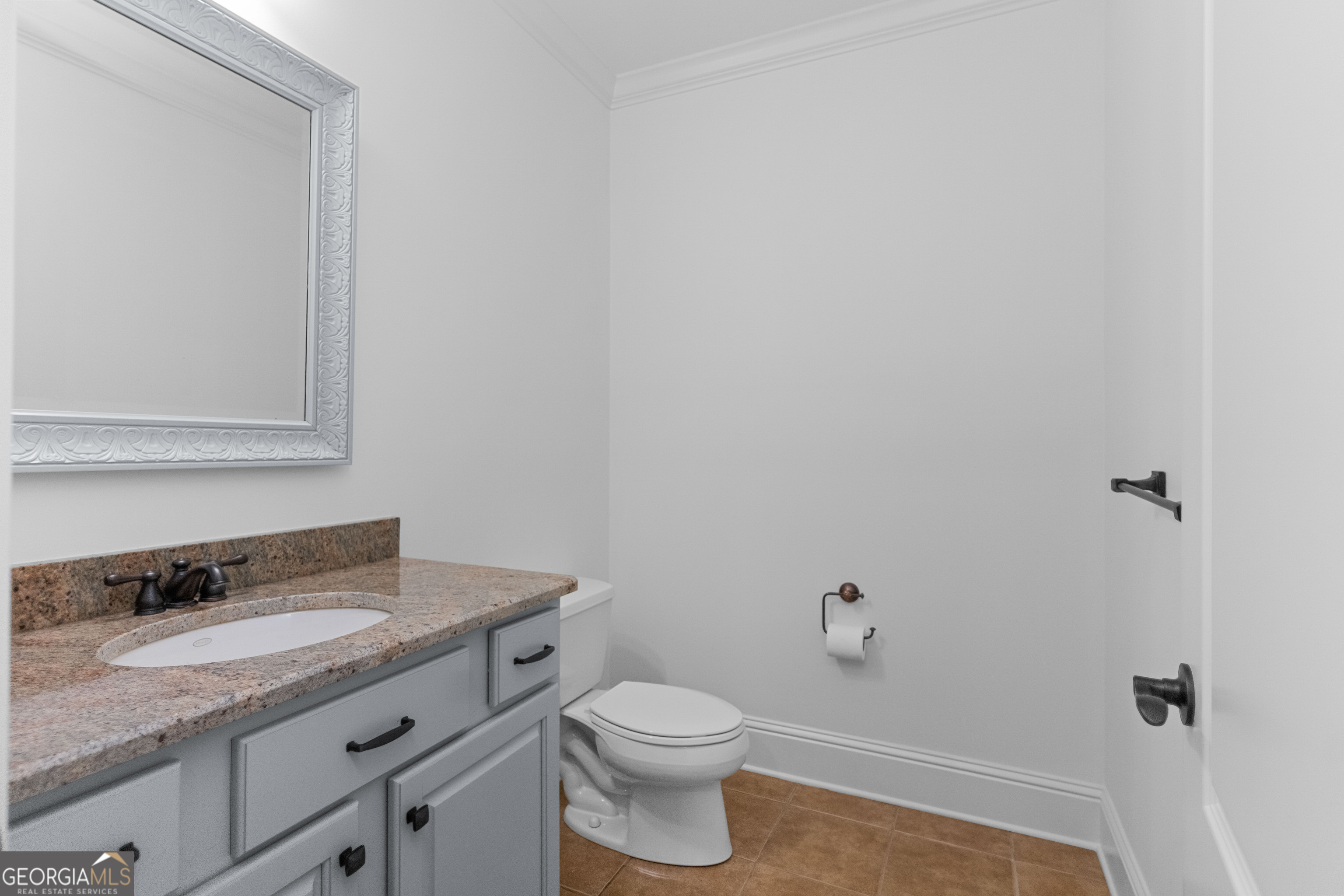 1011 Ridge Terrace Greensboro, GA 30642 - Photo 54 of 72 a bathroom with a granite countertop sink a toilet and a mirror