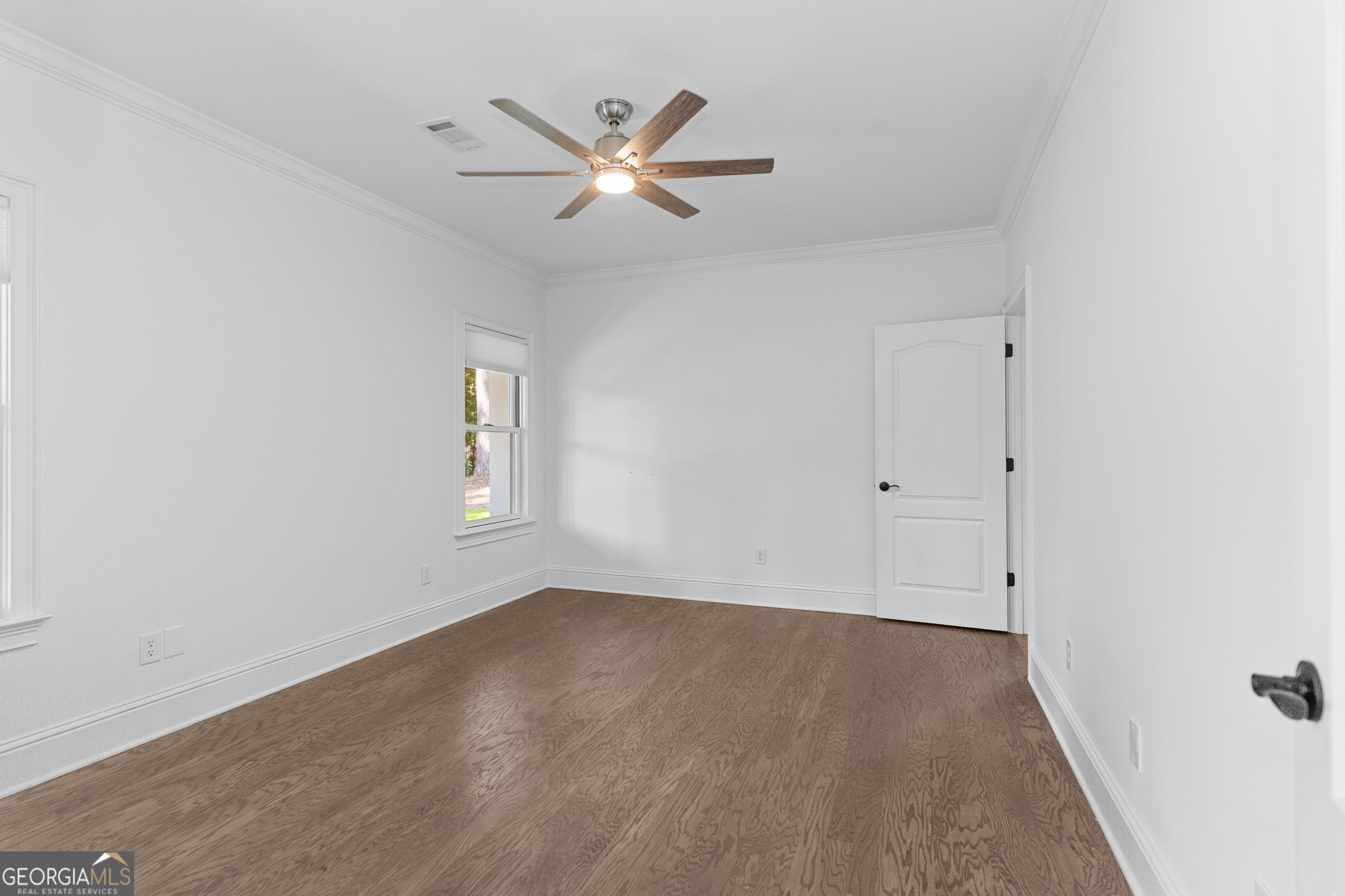 1011 Ridge Terrace Greensboro, GA 30642 - Photo 55 of 72 an empty room with wooden floor and windows
