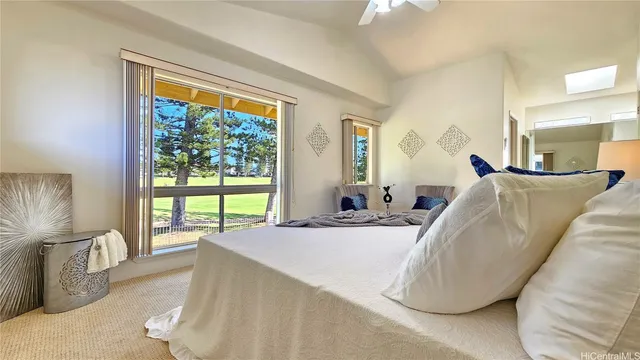 a bed sitting in a spacious bedroom next to a window