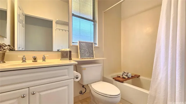 a bathroom with a toilet a sink a tub and mirror