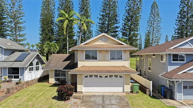 a front view of a house with a garden