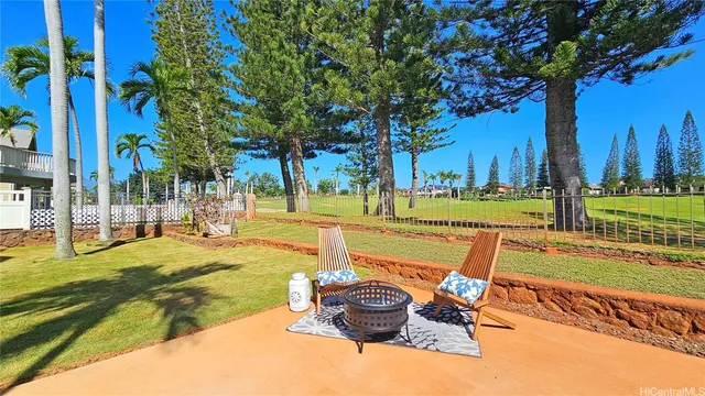 a view of a swimming pool with a patio and a yard