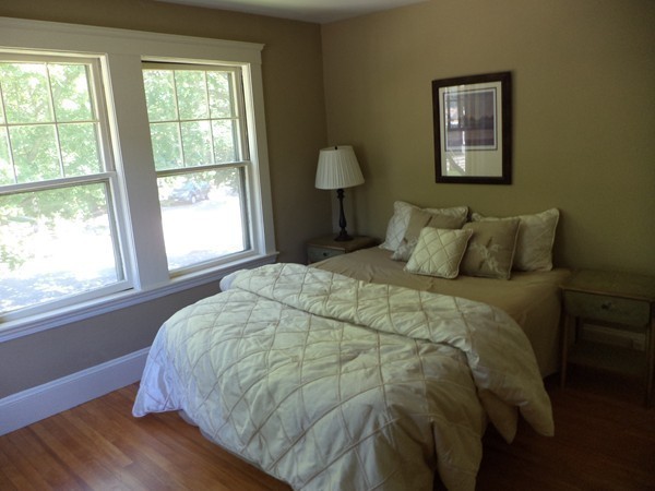11 Jackson Road Medford, MA 02155 - Photo 11 of 12 a large bed sitting in a bedroom next to a window