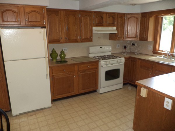 11 Jackson Road Medford, MA 02155 - Photo 5 of 12 a kitchen with stainless steel appliances granite countertop a refrigerator a stove a sink and a microwave