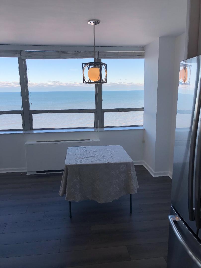 5701 North Sheridan Road, Unit 29T Chicago, IL 60660 - Photo 6 of 11 a view of a room with wooden floor window and fireplace