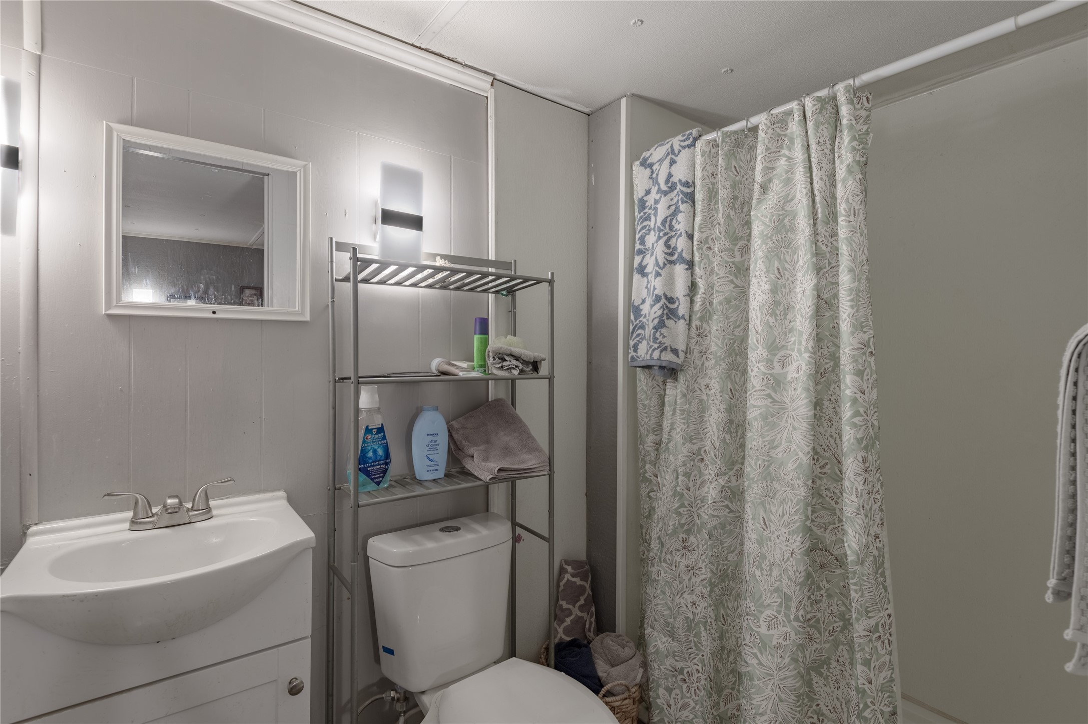 159 Pecan Avenue Groveton, TX 75845 - Photo 14 of 27 a bathroom with a toilet a sink and a mirror