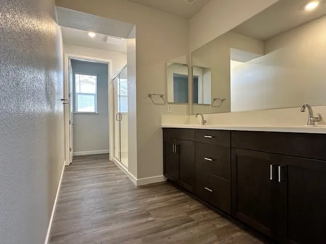 a bathroom with a double vanity sink and mirror