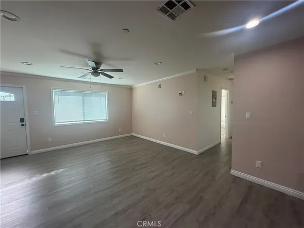wooden floor in an empty room with a window