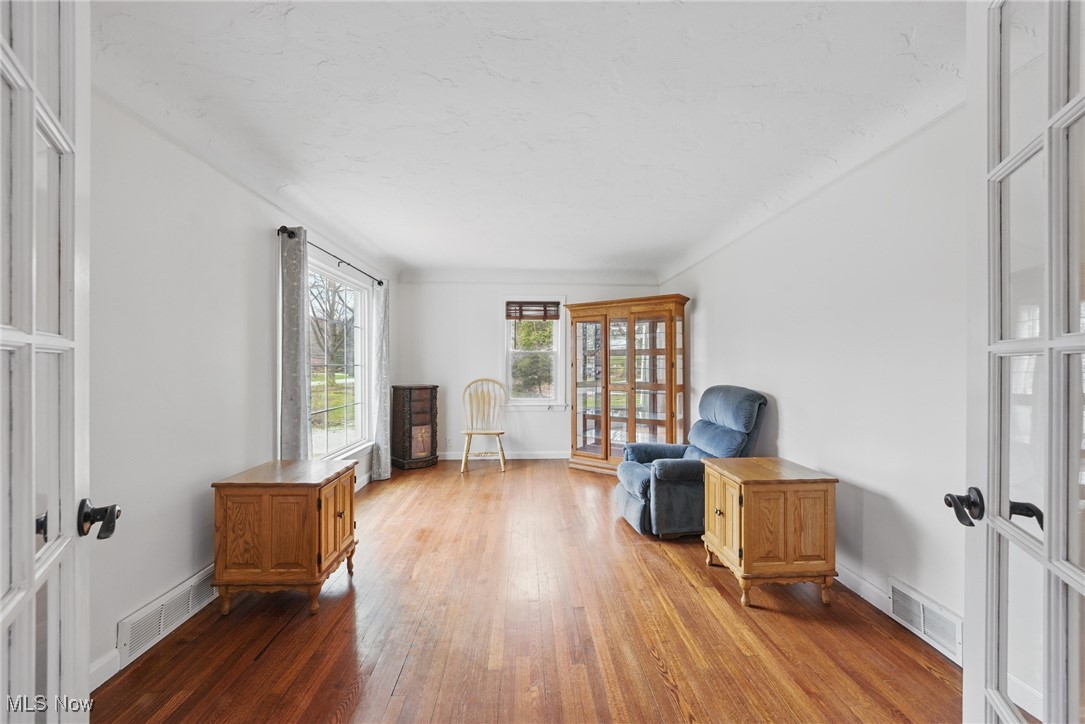 28575 White Road Wickliffe, OH 44092 - Photo 4 of 49 Sitting room featuring french doors, wood-type flooring, and visible vents