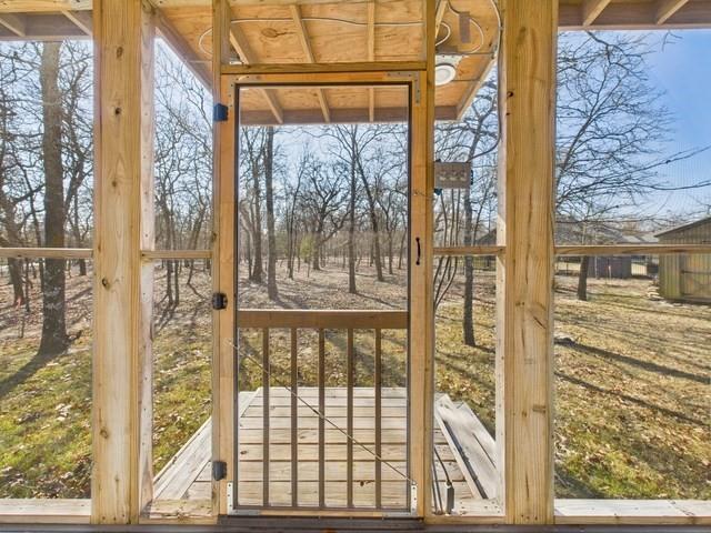 7386 Clint Court Athens, TX 75752 - Photo 9 of 40 a view of a glass door with a tree