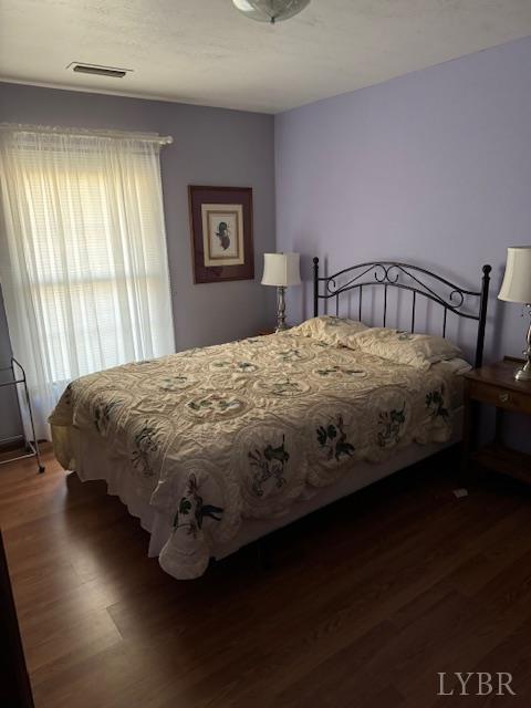 1092 Mount Pleasant Road Pamplin, VA 23958 - Photo 10 of 17 a bedroom with a bed wooden floor and a window