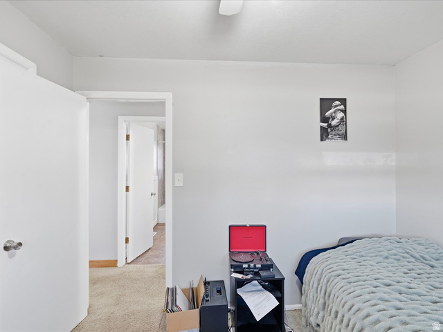 322 East 900 North Logan, UT 84321 - Photo 14 of 43 Bedroom featuring a desk, light carpet, and ceiling fan