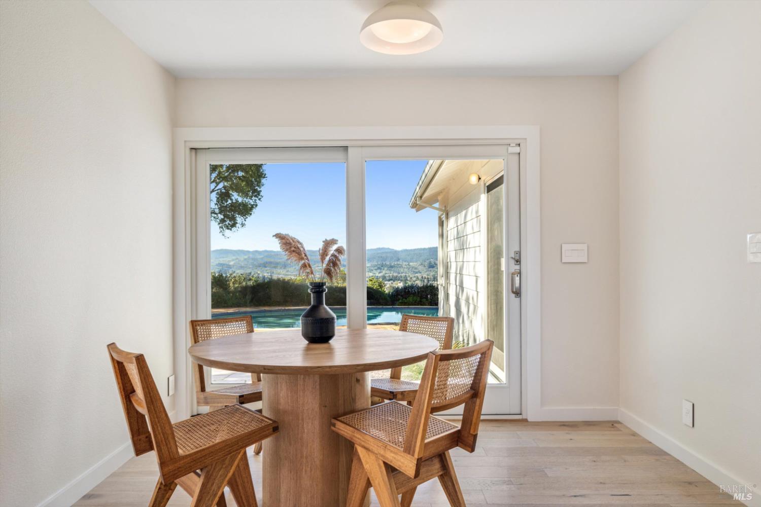 1236 North Fitch Mountain Road Healdsburg, CA 95448 - Photo 36 of 70 a view of a dining room with furniture wooden floor and a potted plant