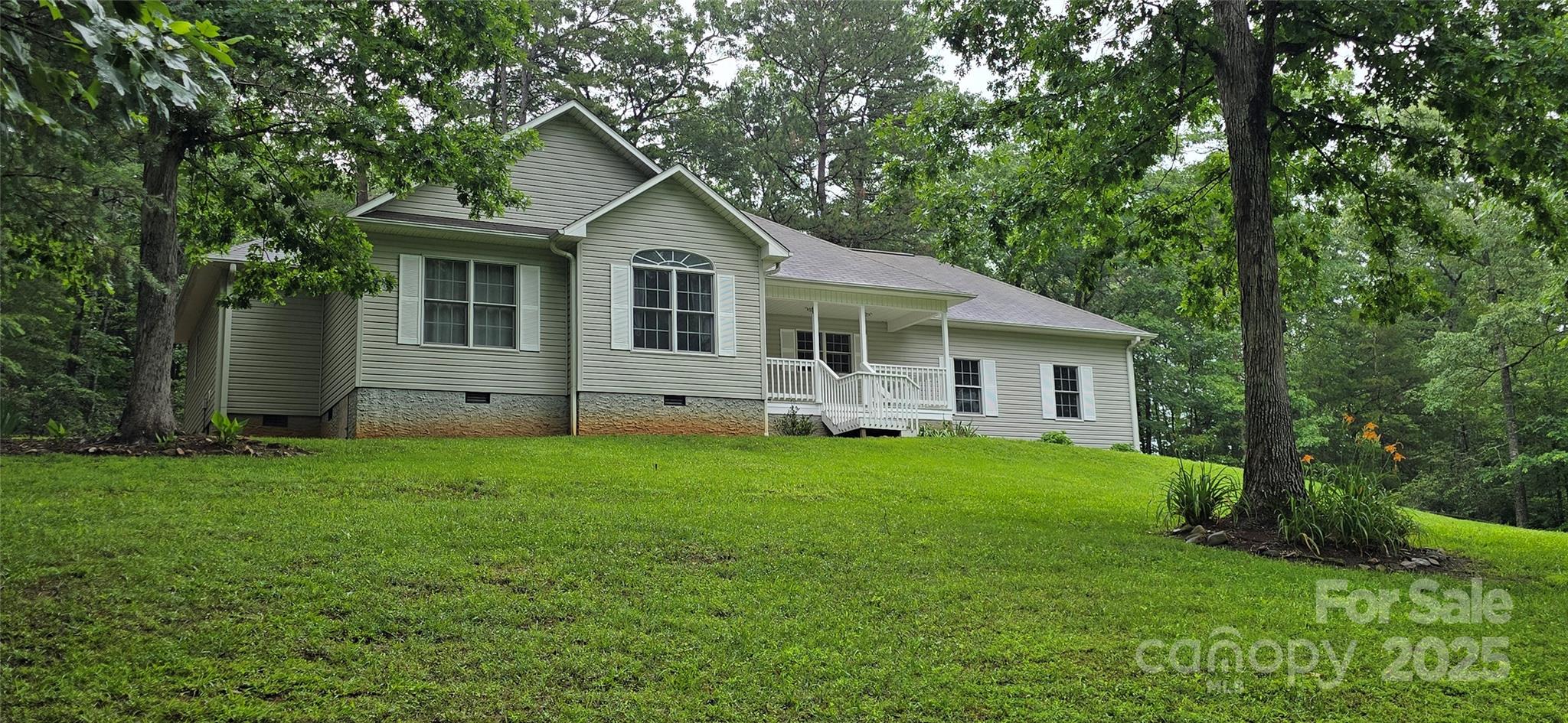 221 Flat Branch Trail Mill Spring, NC 28756 - Photo 1 of 32 a front view of house with yard and green space