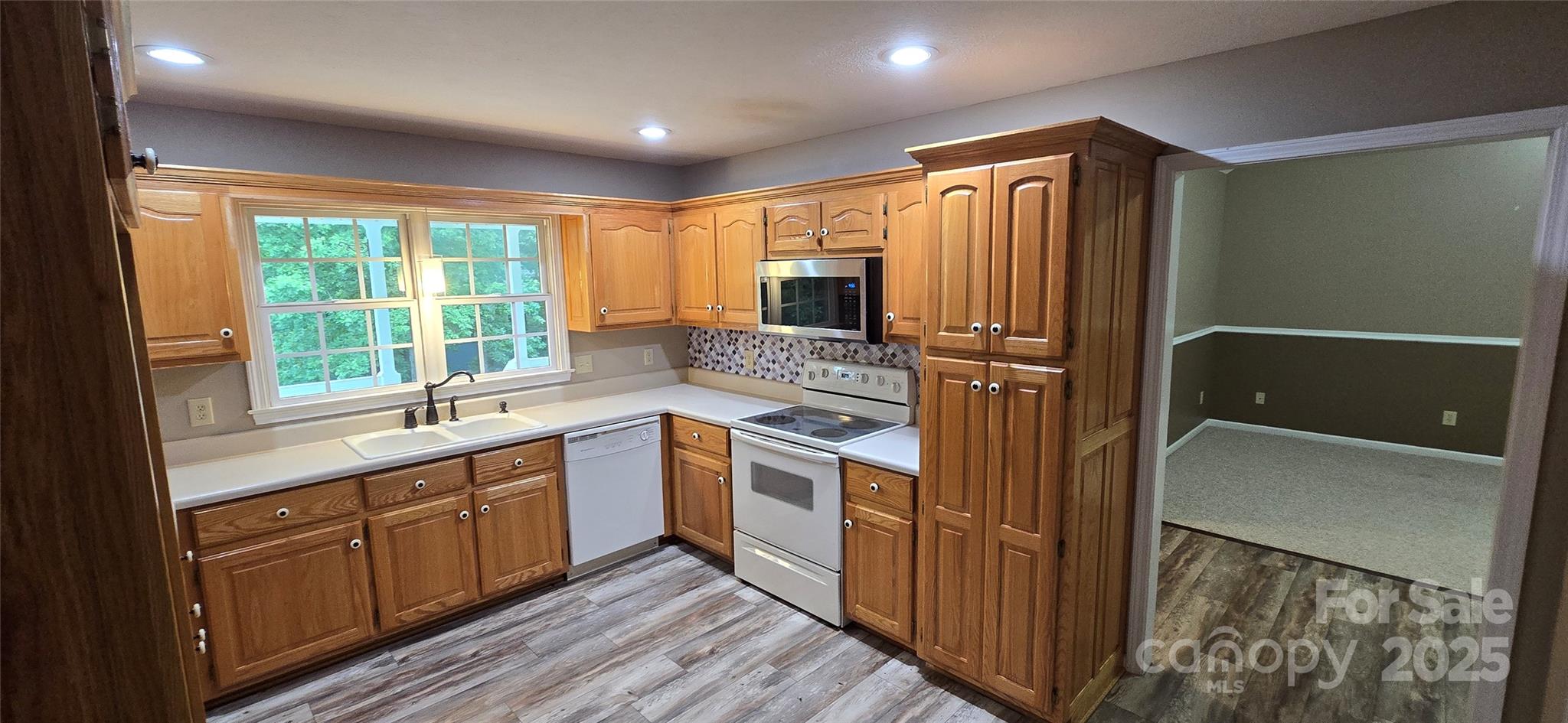 221 Flat Branch Trail Mill Spring, NC 28756 - Photo 11 of 32 a kitchen with a refrigerator sink and microwave