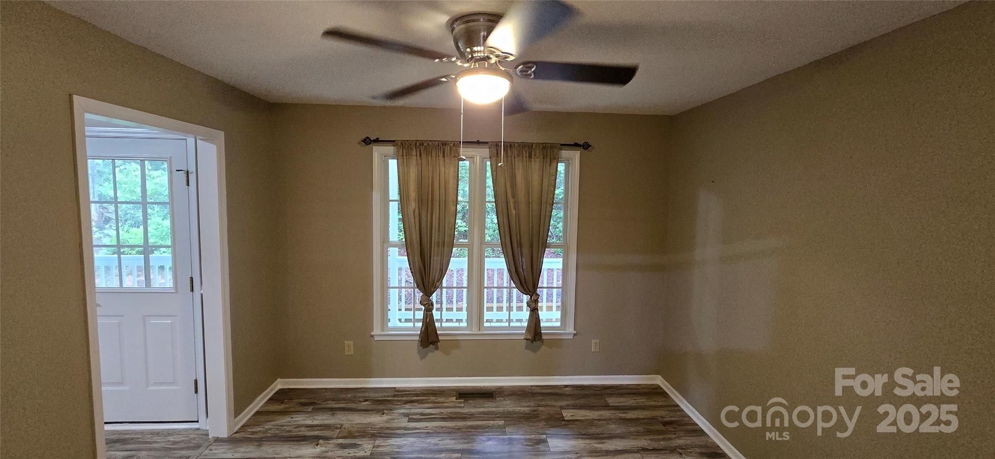 221 Flat Branch Trail Mill Spring, NC 28756 - Photo 14 of 32 a view of an empty room with window and chandelier fan