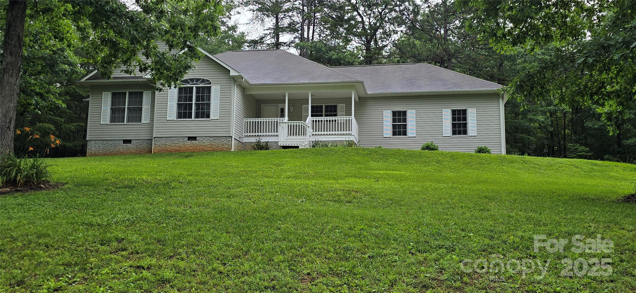 221 Flat Branch Trail Mill Spring, NC 28756 - Photo 3 of 32 a view of a house with a yard and large tree