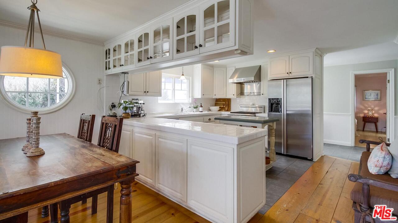 29500 Heathercliff Road, Unit 119 Malibu, CA 90265 - Photo 13 of 47 a kitchen with stainless steel appliances granite countertop a sink a stove and a refrigerator