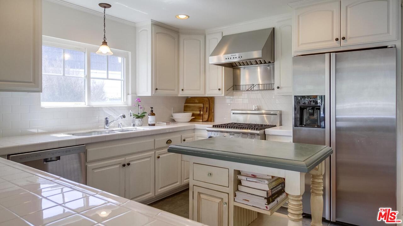 29500 Heathercliff Road, Unit 119 Malibu, CA 90265 - Photo 15 of 47 a kitchen with a sink stainless steel appliances and white cabinets