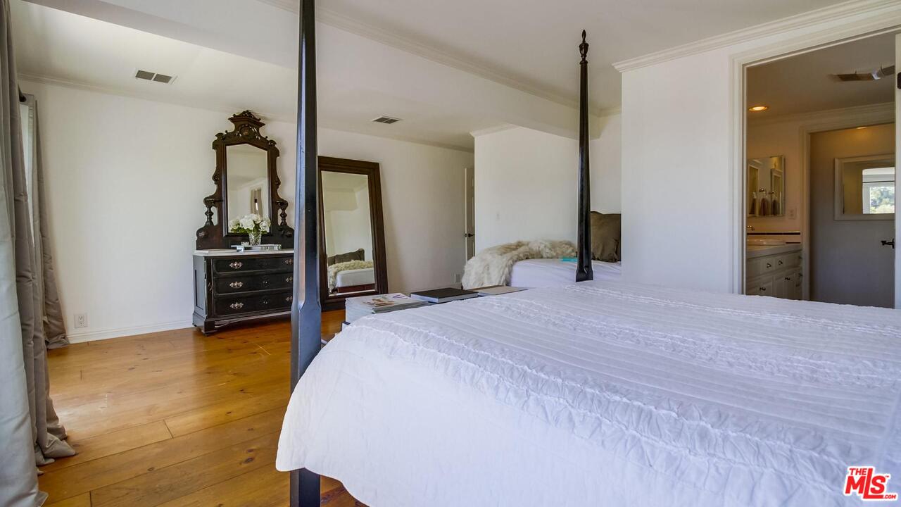 29500 Heathercliff Road, Unit 119 Malibu, CA 90265 - Photo 20 of 47 a bedroom with a bed and a large mirror on the dresser
