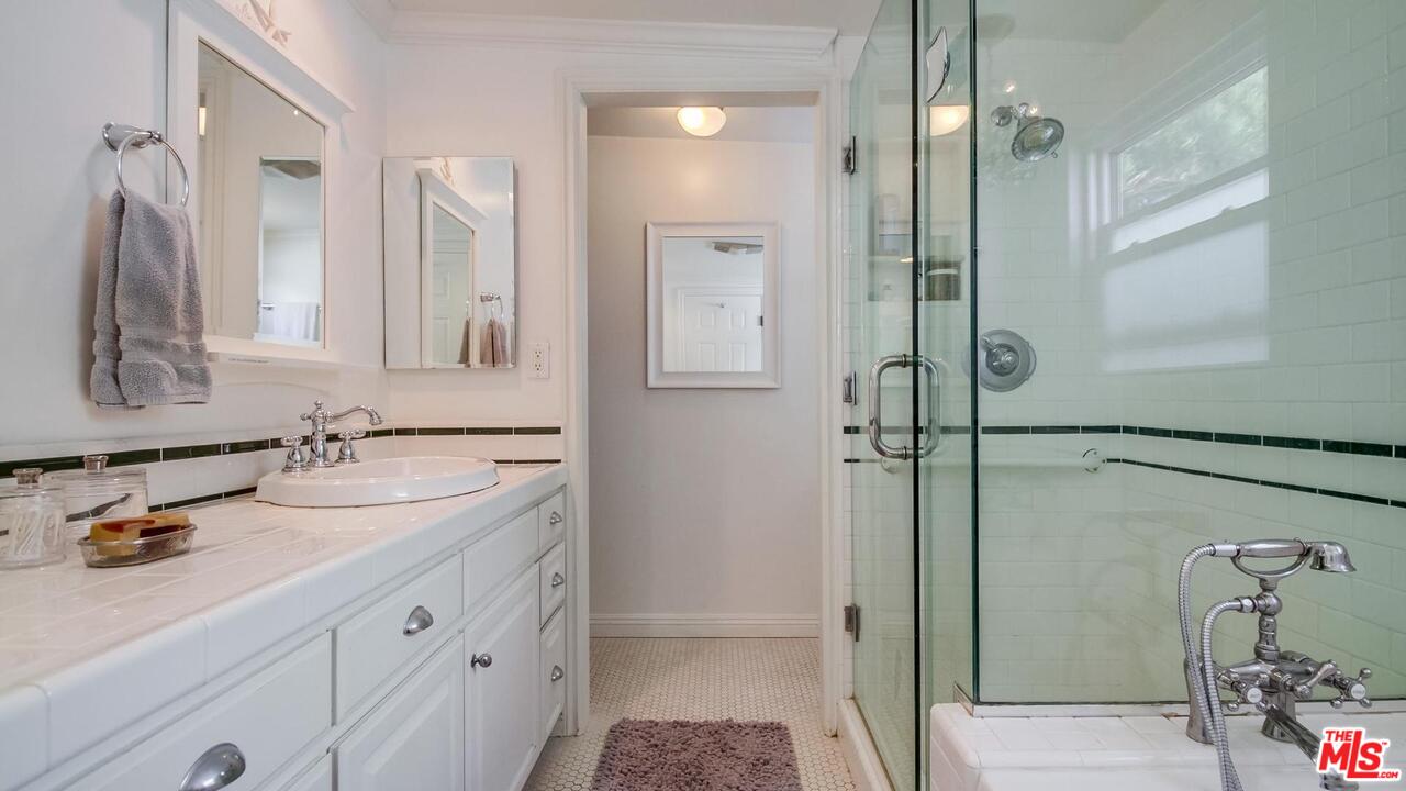 29500 Heathercliff Road, Unit 119 Malibu, CA 90265 - Photo 22 of 47 a bathroom with a double vanity sink mirror and shower