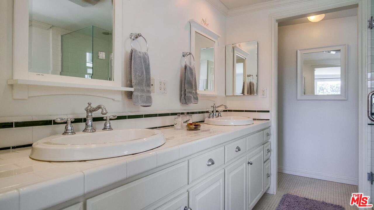 29500 Heathercliff Road, Unit 119 Malibu, CA 90265 - Photo 23 of 47 a bathroom with a double vanity sink and a mirror