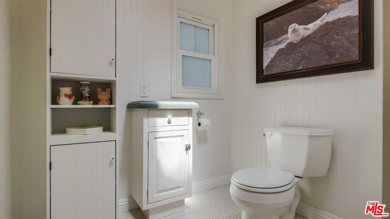 29500 Heathercliff Road, Unit 119 Malibu, CA 90265 - Photo 26 of 47 a bathroom with a toilet and a vanity