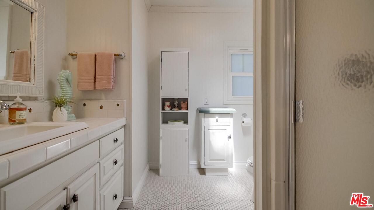 29500 Heathercliff Road, Unit 119 Malibu, CA 90265 - Photo 27 of 47 a bathroom with a sink and a mirror