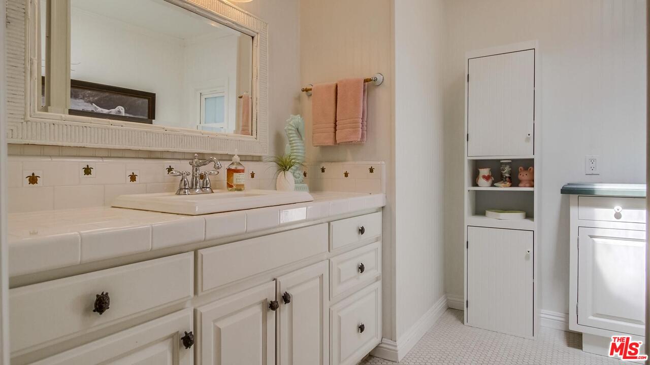 29500 Heathercliff Road, Unit 119 Malibu, CA 90265 - Photo 28 of 47 a bathroom with a sink and a mirror