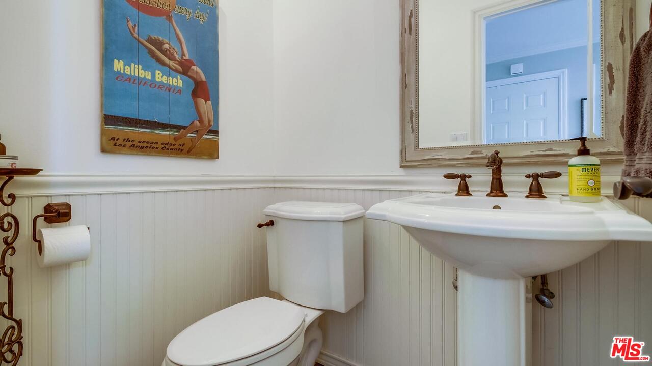 29500 Heathercliff Road, Unit 119 Malibu, CA 90265 - Photo 30 of 47 a bathroom with a toilet sink and mirror