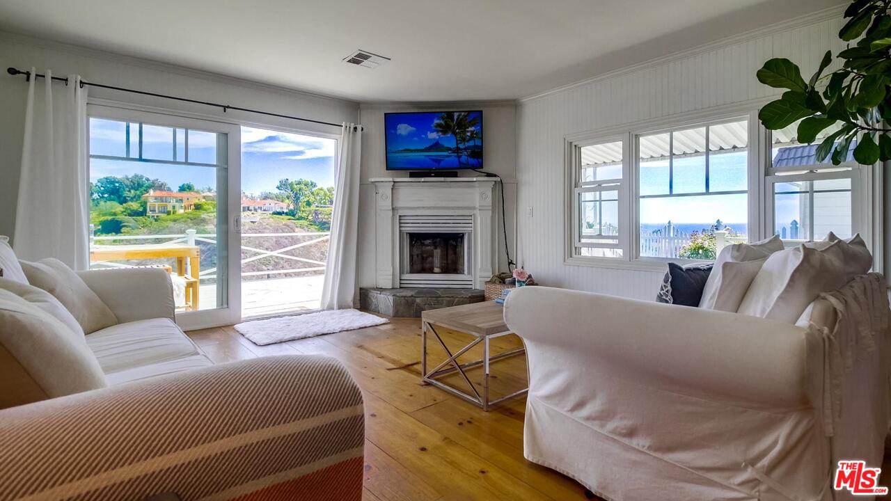 29500 Heathercliff Road, Unit 119 Malibu, CA 90265 - Photo 4 of 47 a living room with furniture and a fireplace