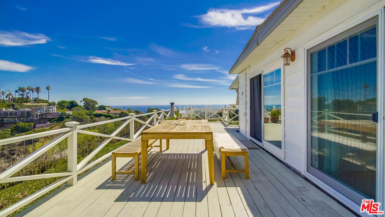 29500 Heathercliff Road, Unit 119 Malibu, CA 90265 - Photo 35 of 47 a view of a balcony with wooden floor